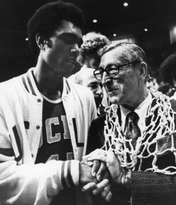 Junior point guard Andre McCarter ’76 embraces Wooden after the Bruins' championship triumph on March 31, 1975