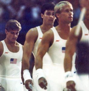 Three of the six members of the U.S. men’s gymnastics gold-medal winning team line up in Pauley Pavilion. The UCLA athletes pictured are Peter Vidmar ’83 (left) and Mitch Gaylord (center).