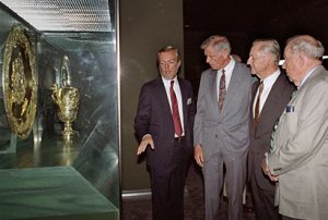 From left, Fowler Museum Director Christopher Donnan gives a tour on opening day to Chancellor Charles E. Young, Philip Fowler and Chancellor Franklin D. Murphy. Donnan highlights several of the more than 250 silver pieces donated by the museum's primary benefactor Francis E. Fowler, Jr.