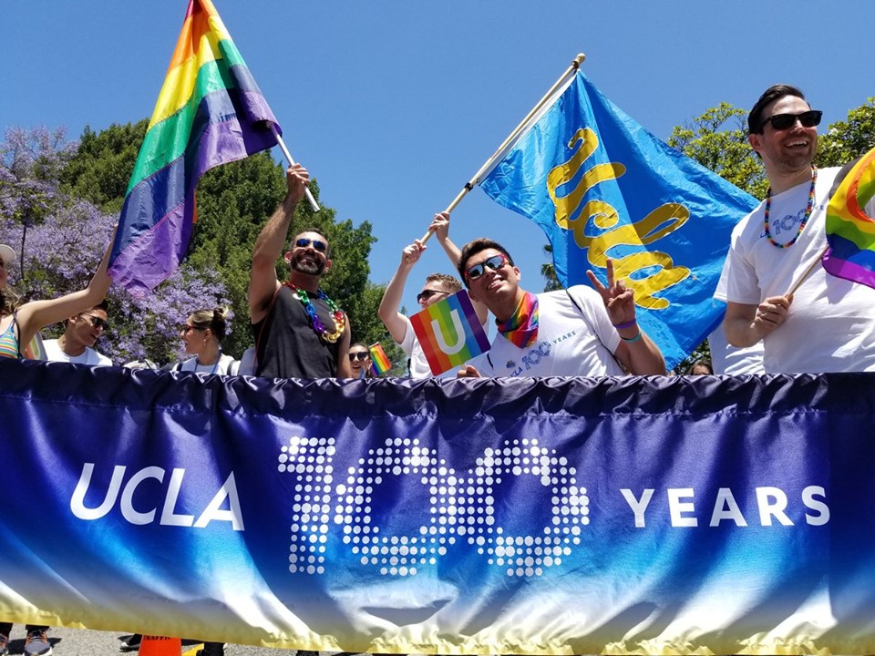 People holding UCLA and Lambda flags