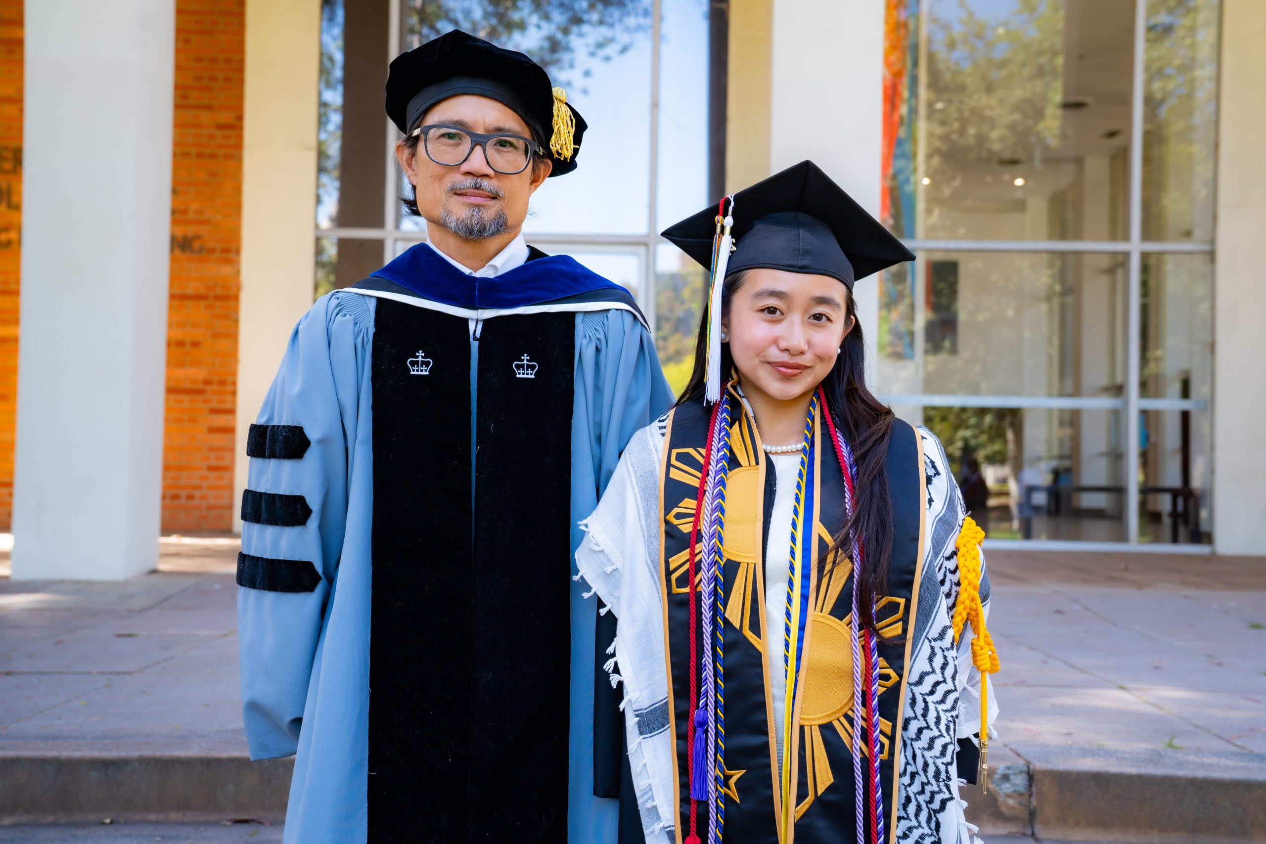 Two Pilipino alums in cap and gown