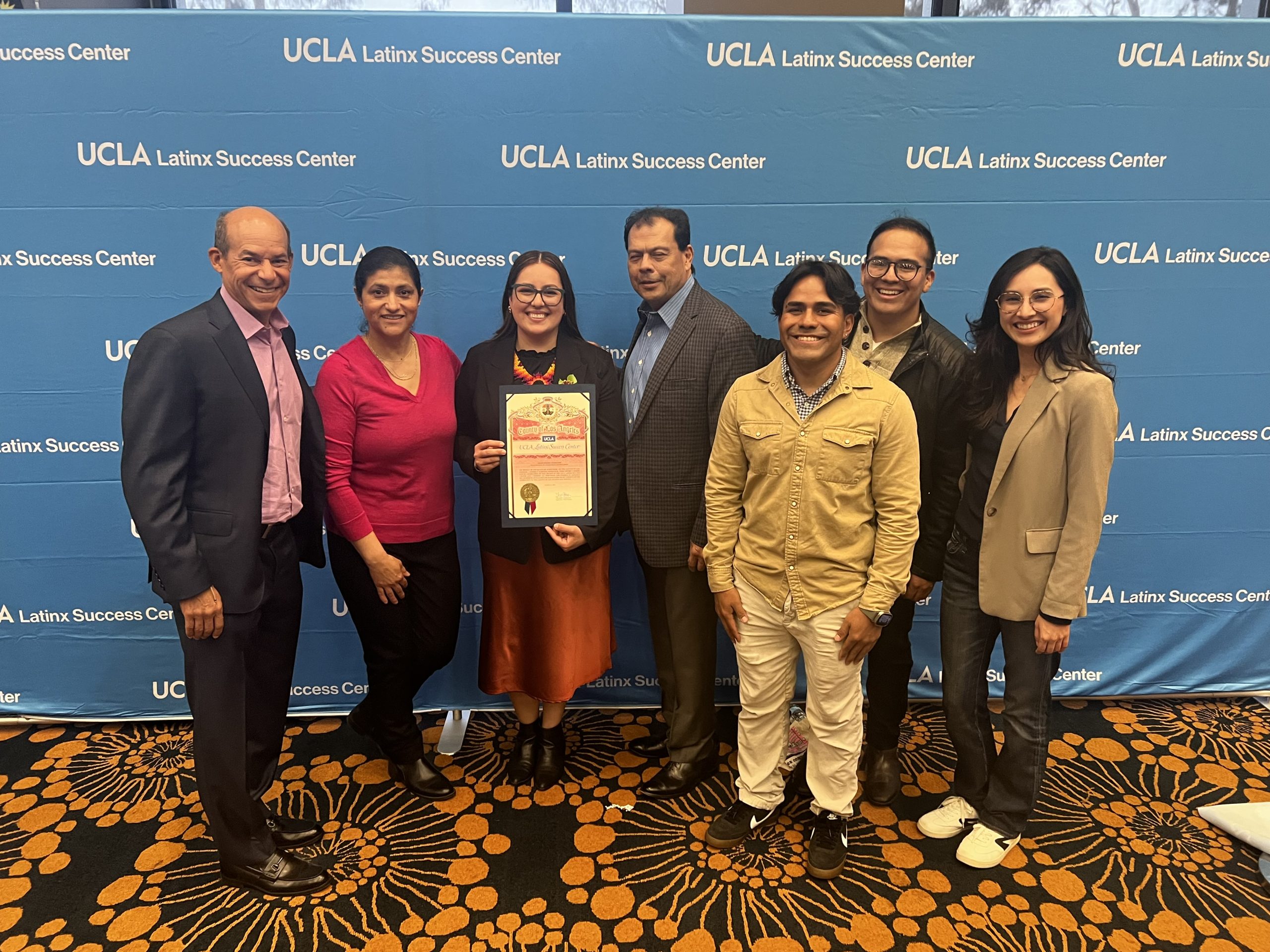 Latino alums in front of UCLA Latinx Success Center step and repeat