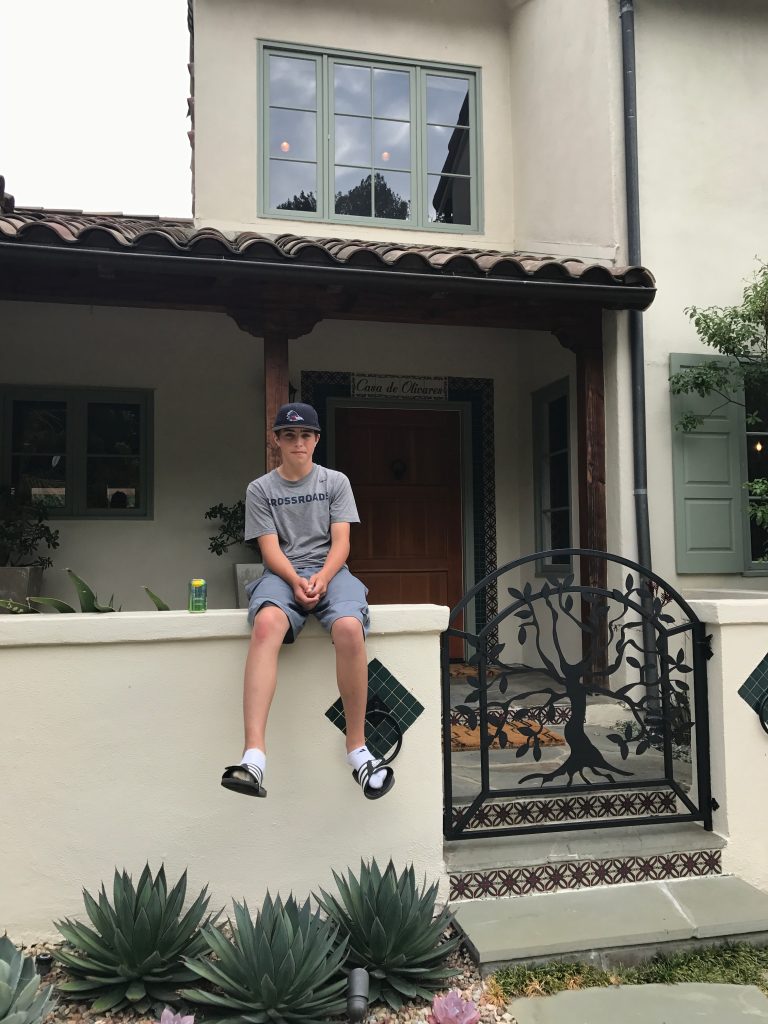 Young Leo in front of his house