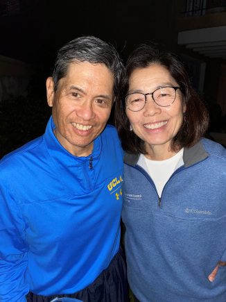 Photo of Ron and Peggy Yee, 2021-22 UCLA Parents' Council Co-Chairs, standing together and smiling toward the camera.
