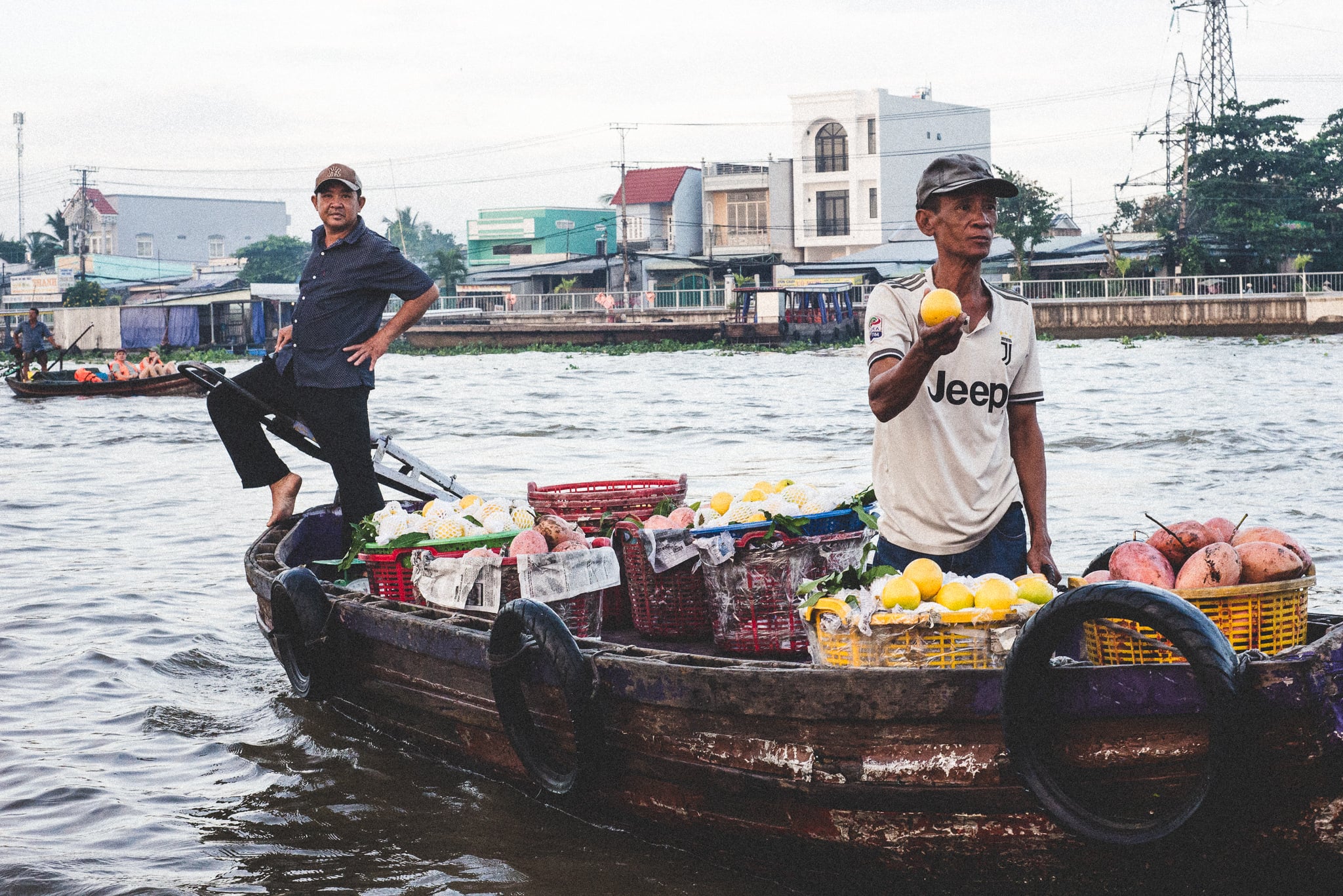 Fruit vendors on boat in Can Tho by Hon Hoang